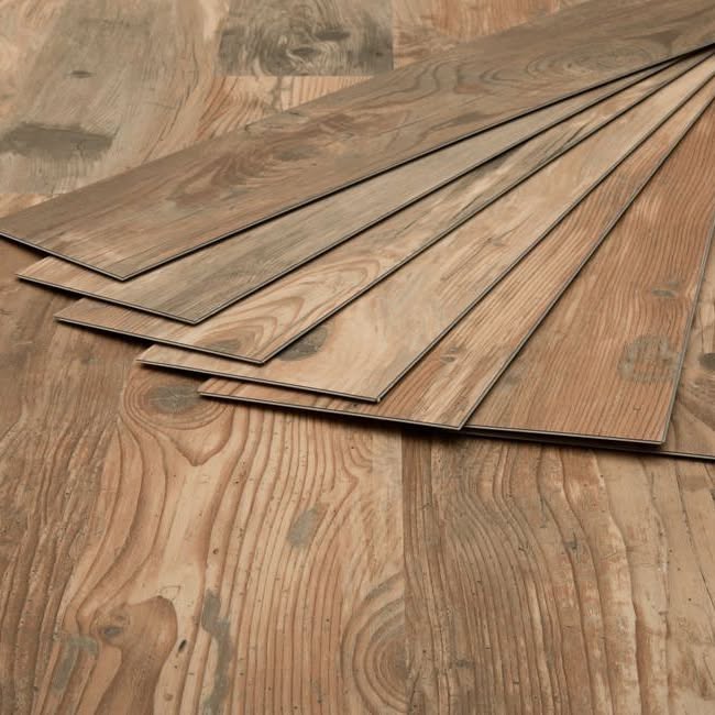 Luxury vinyl plank samples fanned out showing textured wood grain detail